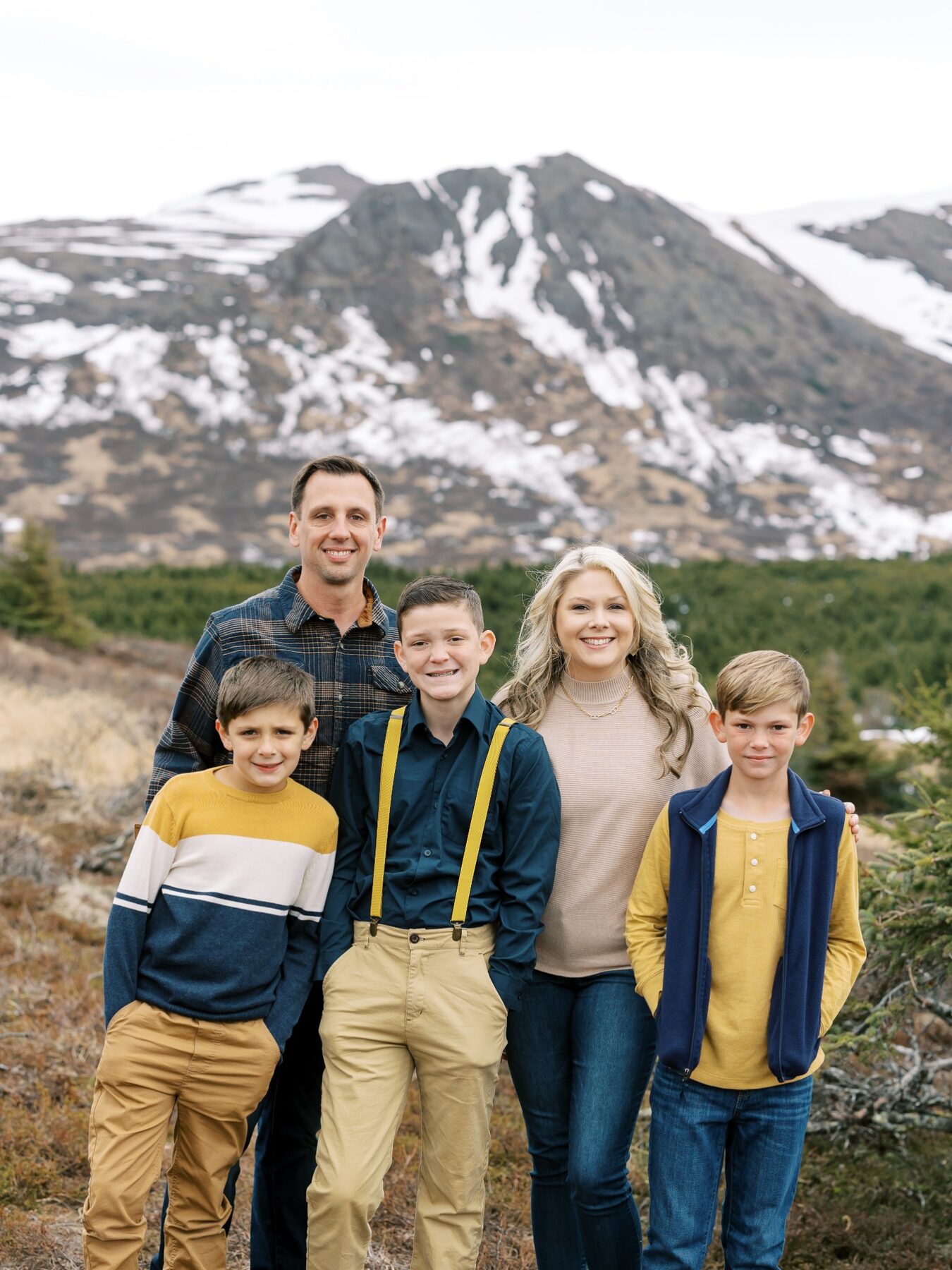 Donavan and Katy Arnold with their three sons in front of a mountain landscape