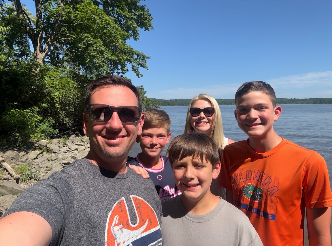 Donavan, Katy, and their three sons beside a lake