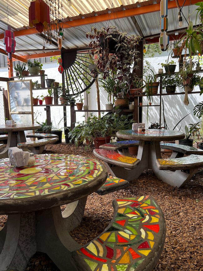 Colorful mosaic tables and plants at a Gainesville garden restaurant